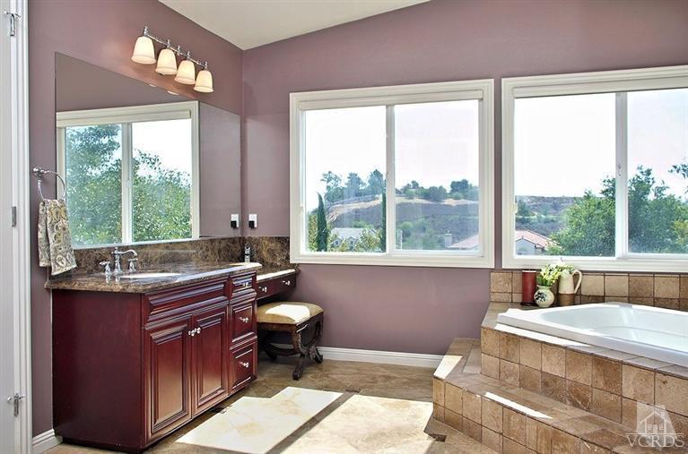 12428 Palmer Drive Moorpark, CA 93021 - Photo 23 of 42 a bathroom with a granite countertop sink and a large mirror