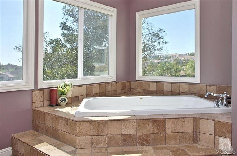 12428 Palmer Drive Moorpark, CA 93021 - Photo 24 of 42 a bath tub sitting in a bathroom next to a window