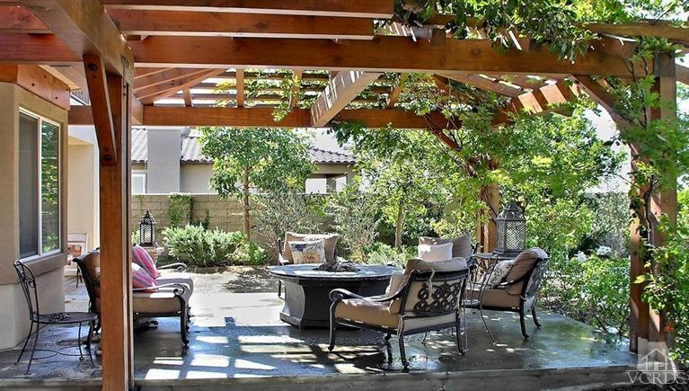 12428 Palmer Drive Moorpark, CA 93021 - Photo 32 of 42 a view of a patio with table and chairs potted plants with wooden floor