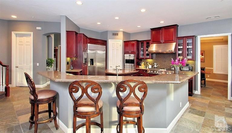 12428 Palmer Drive Moorpark, CA 93021 - Photo 8 of 42 a kitchen with stainless steel appliances granite countertop a table chairs and a refrigerator