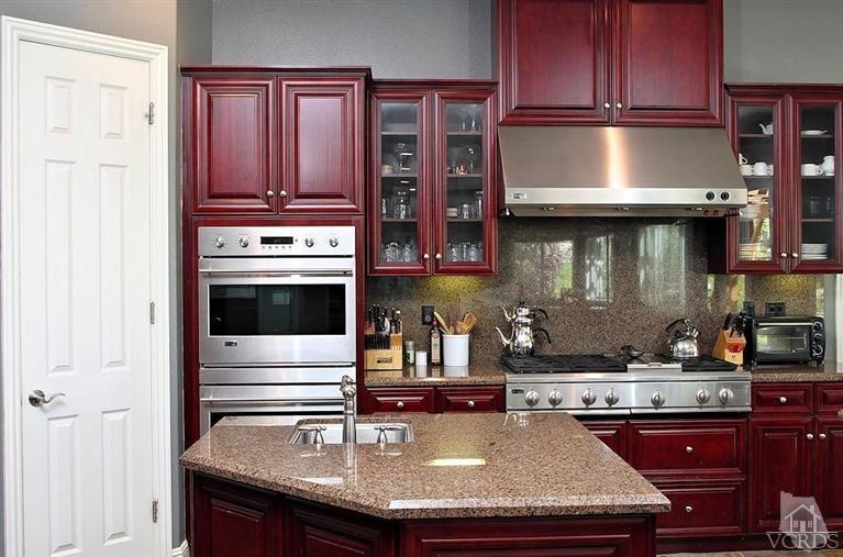 12428 Palmer Drive Moorpark, CA 93021 - Photo 10 of 42 a kitchen with kitchen island granite countertop a stove and a refrigerator