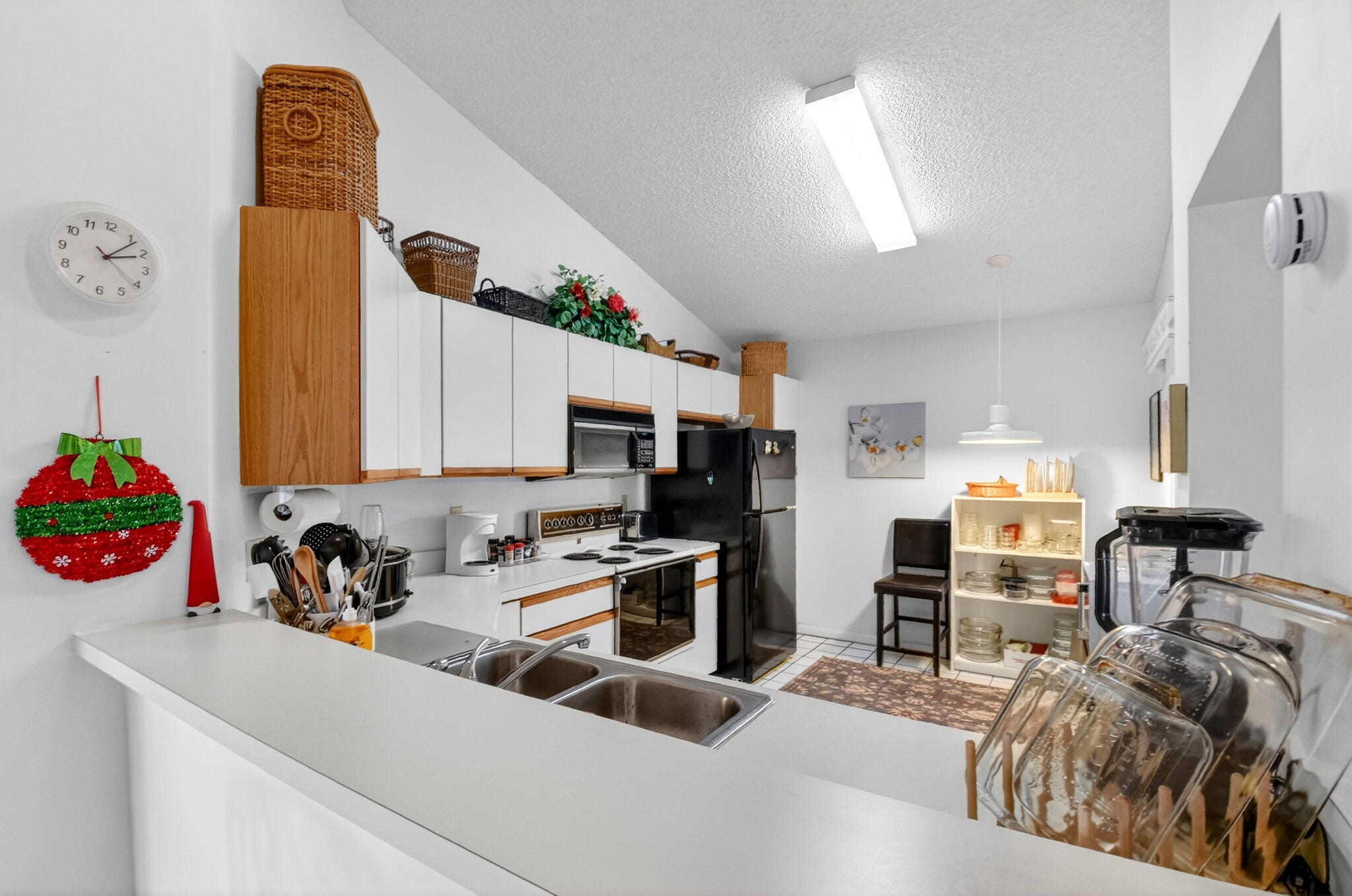 3227 Perimeter Drive Greenacres, FL 33467 - Photo 16 of 57 a kitchen with a sink and a stove top oven