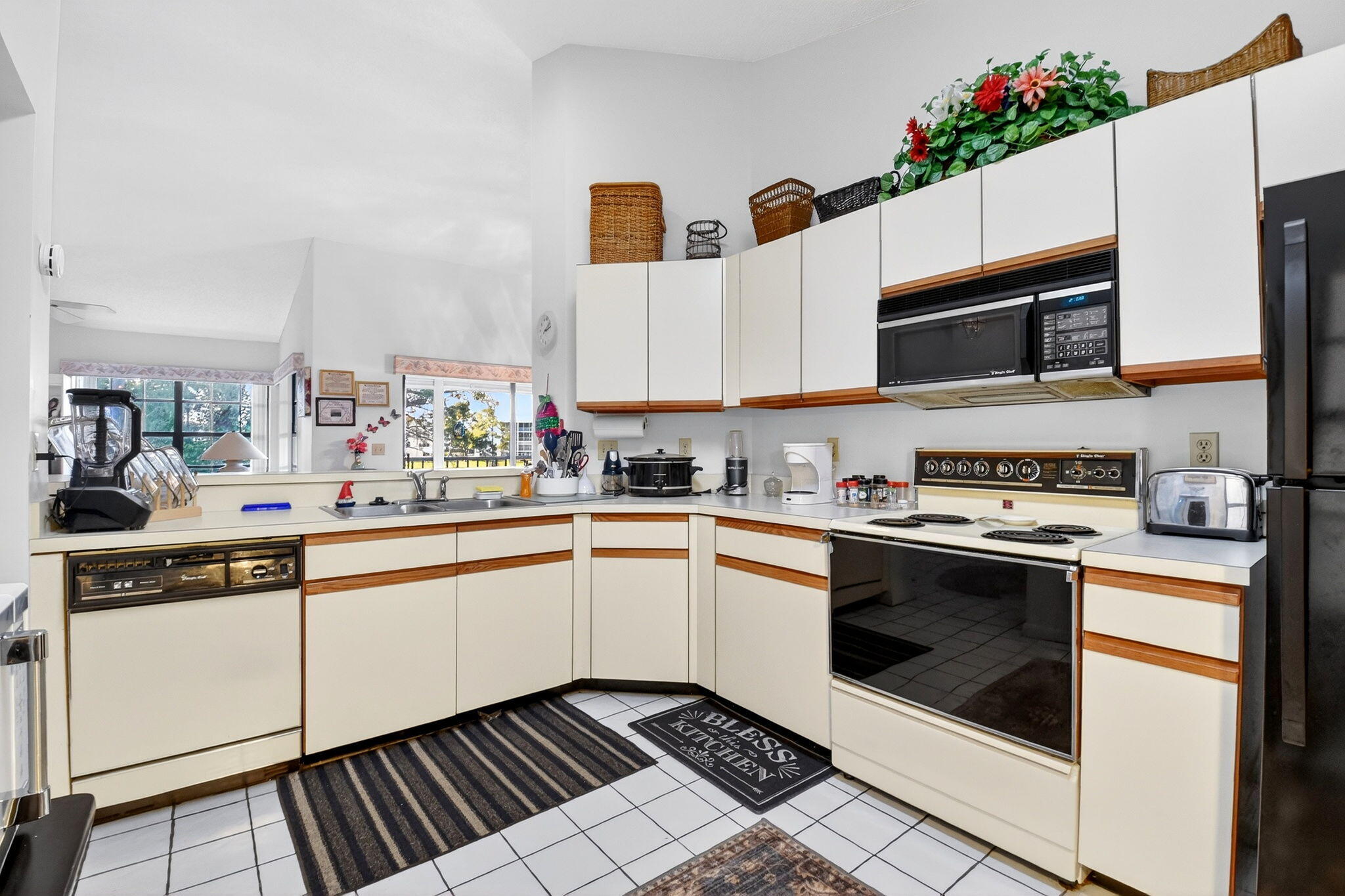 3227 Perimeter Drive Greenacres, FL 33467 - Photo 18 of 57 a kitchen with stainless steel appliances a stove a microwave sink and cabinets
