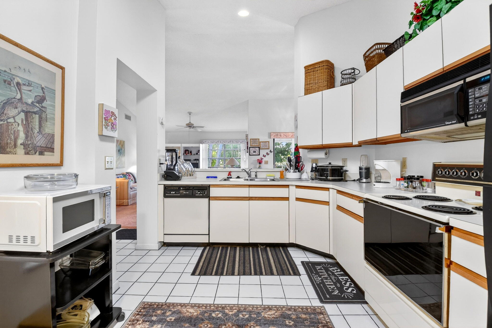 3227 Perimeter Drive Greenacres, FL 33467 - Photo 19 of 57 a kitchen with stainless steel appliances a stove a sink and a microwave