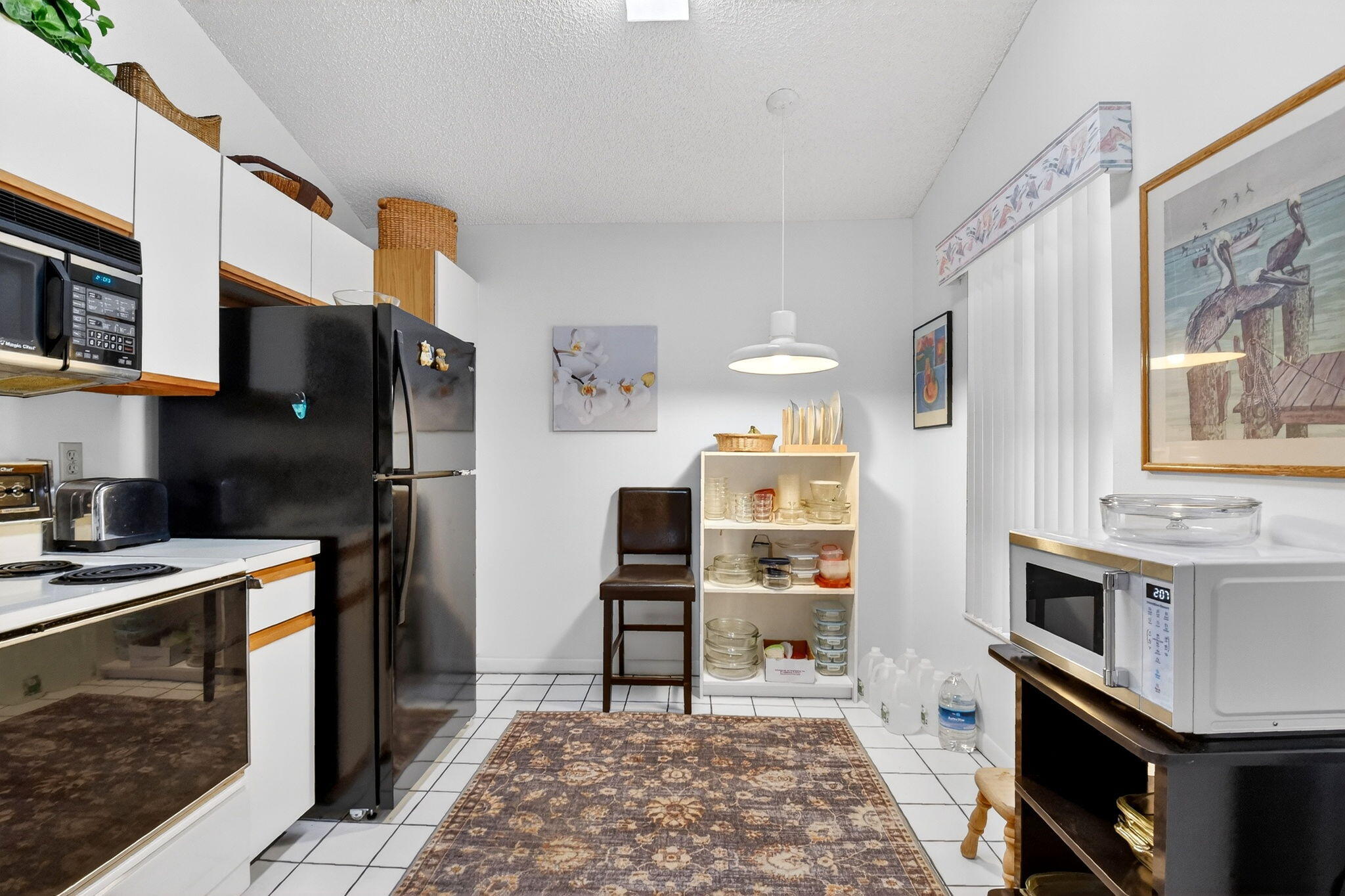 3227 Perimeter Drive Greenacres, FL 33467 - Photo 20 of 57 a kitchen with stainless steel appliances kitchen island granite countertop a refrigerator stove and sink