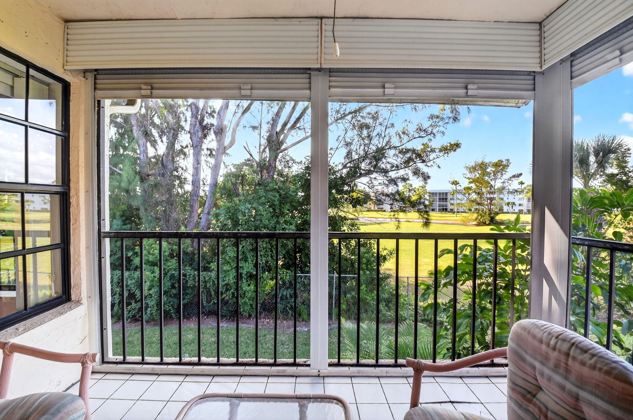 3227 Perimeter Drive Greenacres, FL 33467 - Photo 24 of 57 a view of a porch with a bench next to a yard