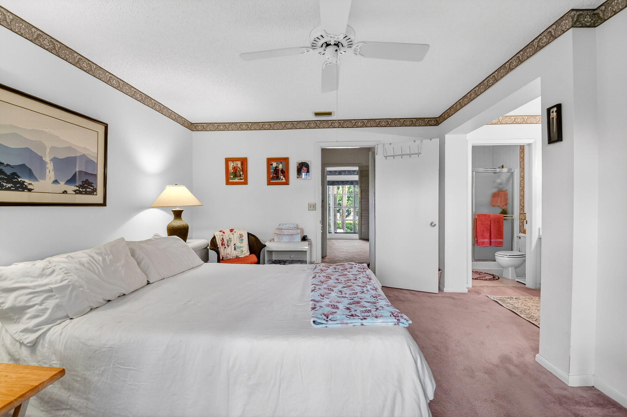 3227 Perimeter Drive Greenacres, FL 33467 - Photo 27 of 57 a bedroom with a large bed and a chandelier