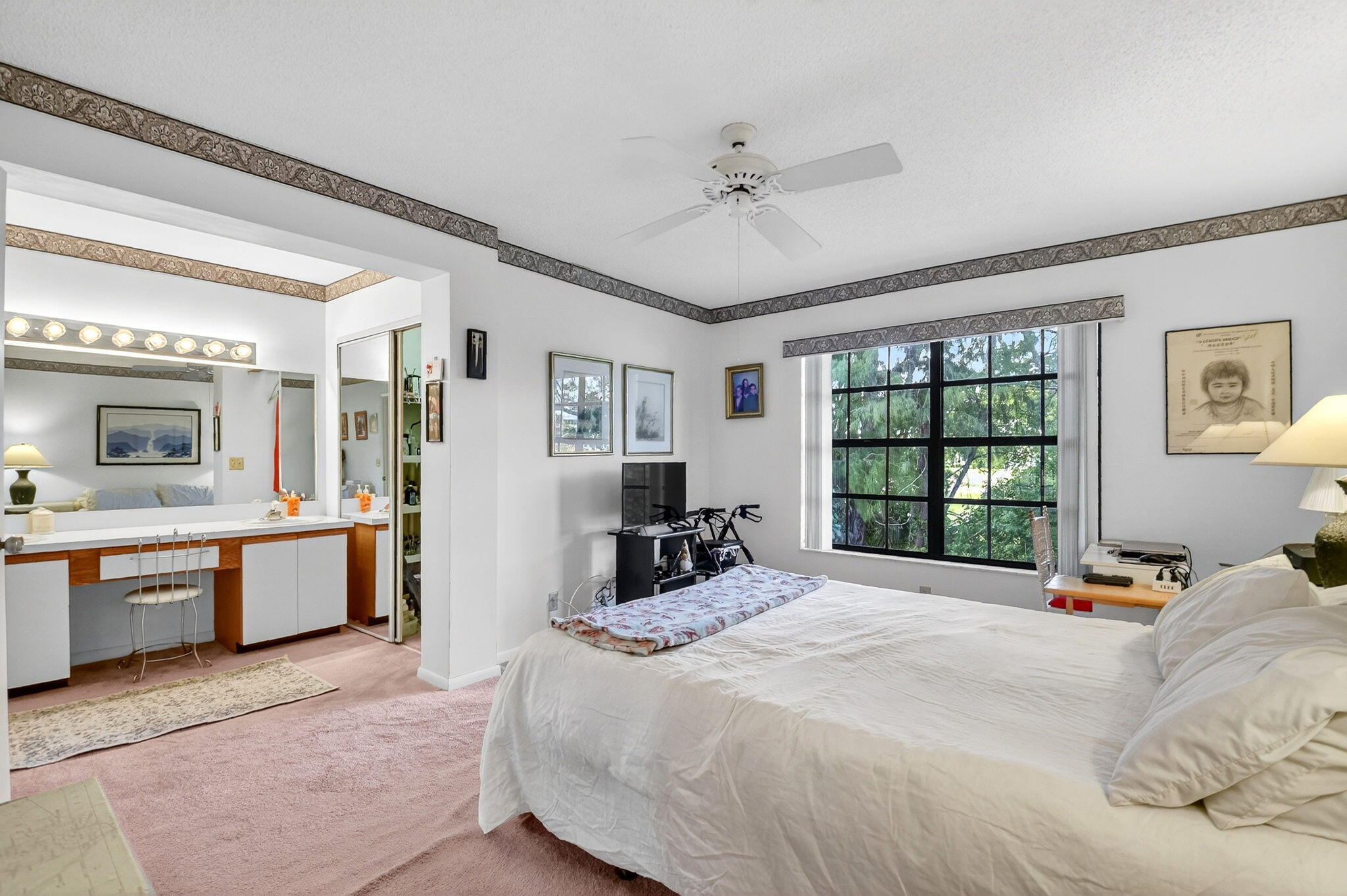 3227 Perimeter Drive Greenacres, FL 33467 - Photo 30 of 57 a bedroom with a large bed and a chandelier