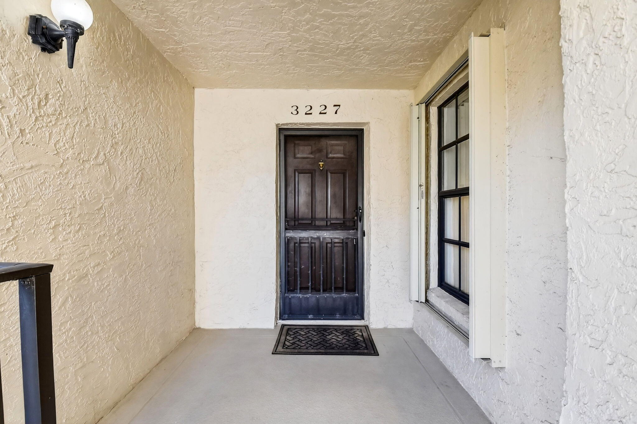 3227 Perimeter Drive Greenacres, FL 33467 - Photo 5 of 57 a view of a hallway with wooden door