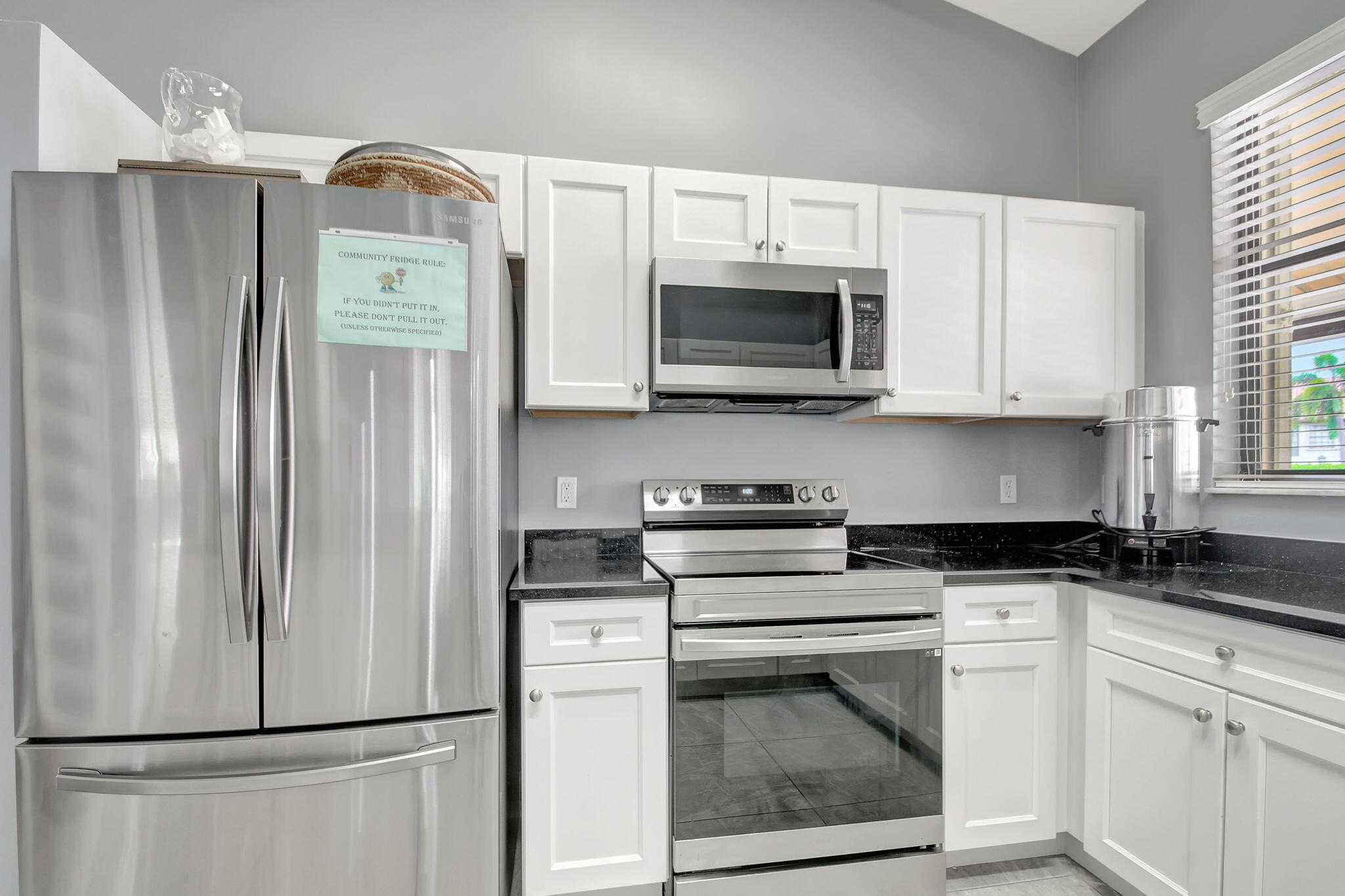 3227 Perimeter Drive Greenacres, FL 33467 - Photo 56 of 57 a kitchen with stainless steel appliances a refrigerator stove and microwave