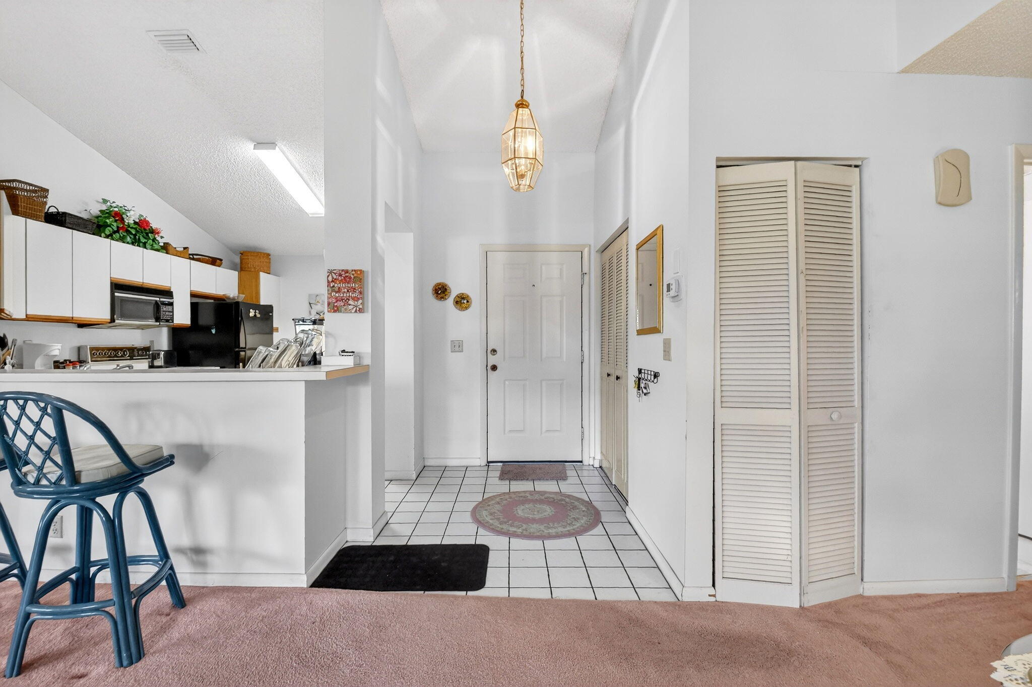 3227 Perimeter Drive Greenacres, FL 33467 - Photo 8 of 57 a living room with furniture and a dining table with kitchen view
