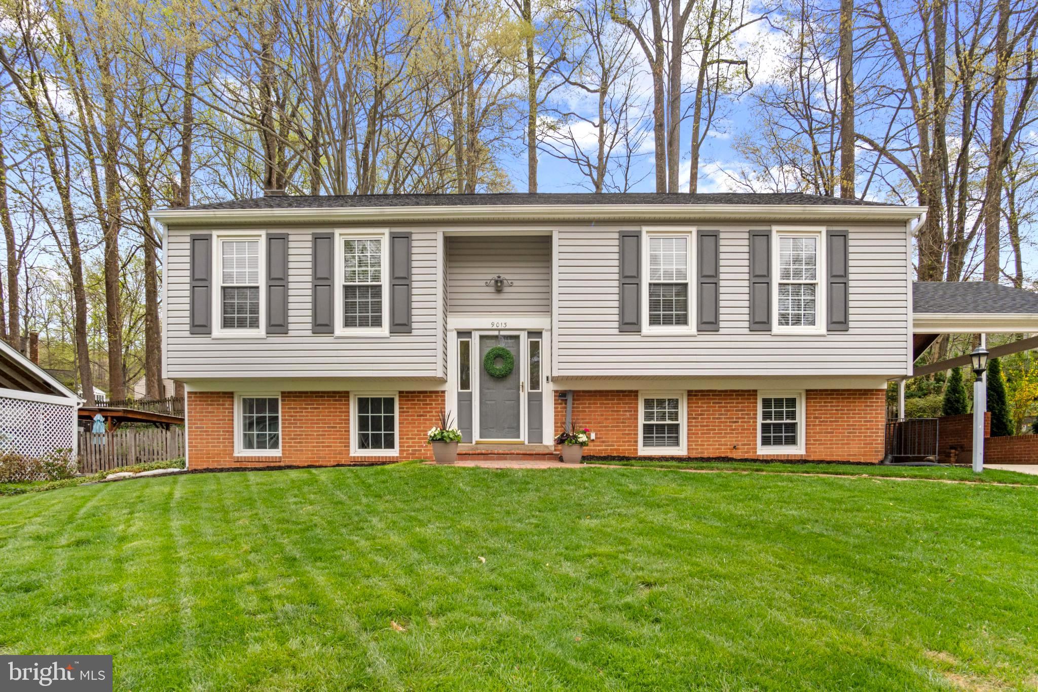 9013 Brook Ford Road Burke, VA 22015 - Photo 1 of 28 a front view of a building with a garden