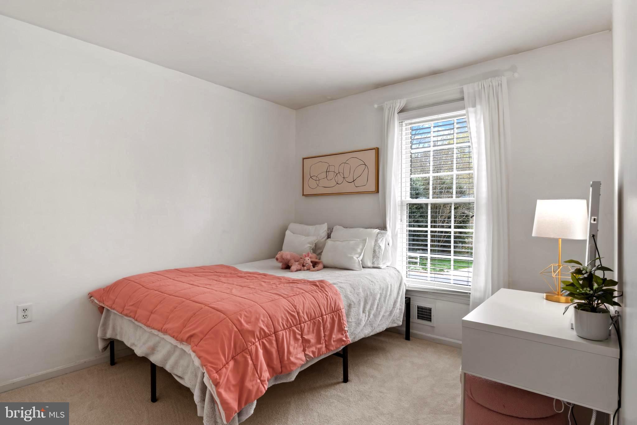 9013 Brook Ford Road Burke, VA 22015 - Photo 15 of 28 a bedroom with a bed window and table