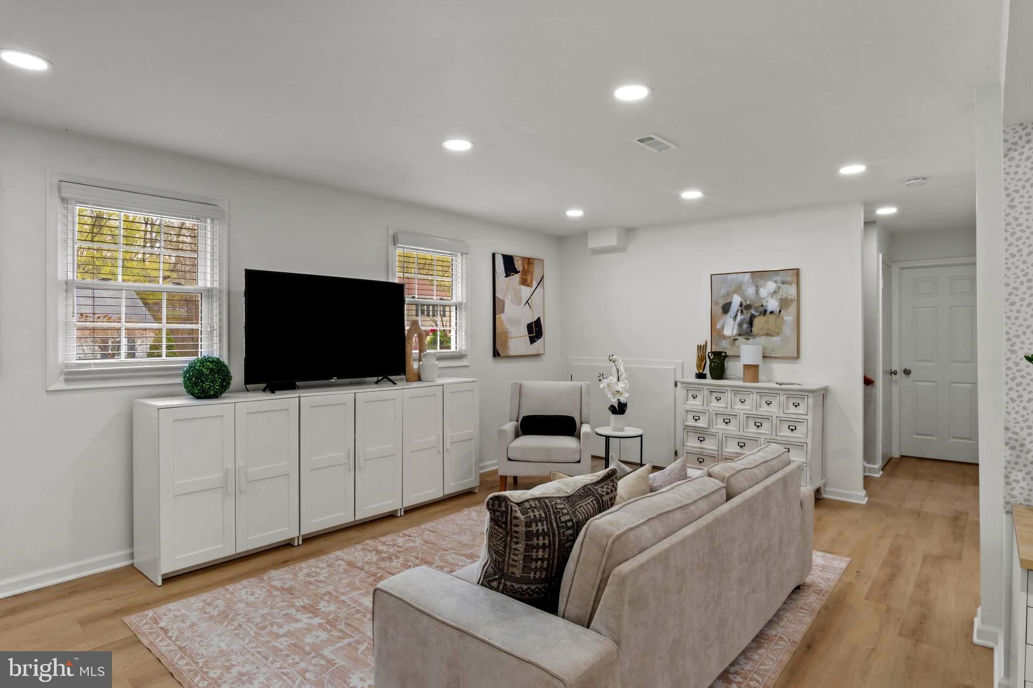 9013 Brook Ford Road Burke, VA 22015 - Photo 20 of 28 a living room with furniture and a flat screen tv