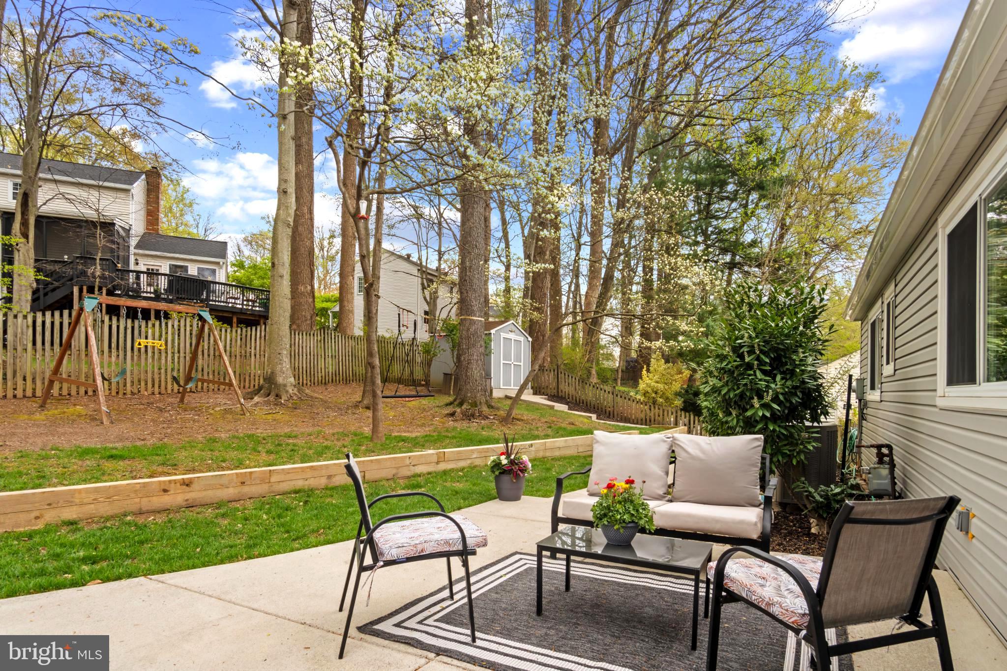 9013 Brook Ford Road Burke, VA 22015 - Photo 24 of 28 a view of a chairs and tables in the backyard