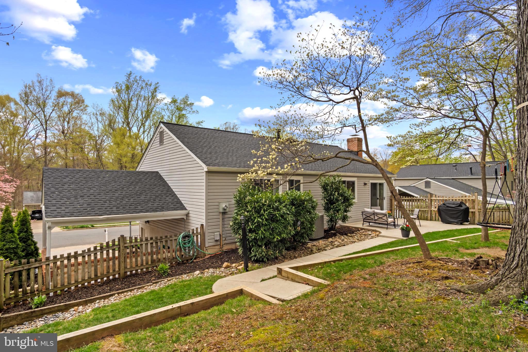 9013 Brook Ford Road Burke, VA 22015 - Photo 25 of 28 a view of a house with a large tree and a yard in front of it
