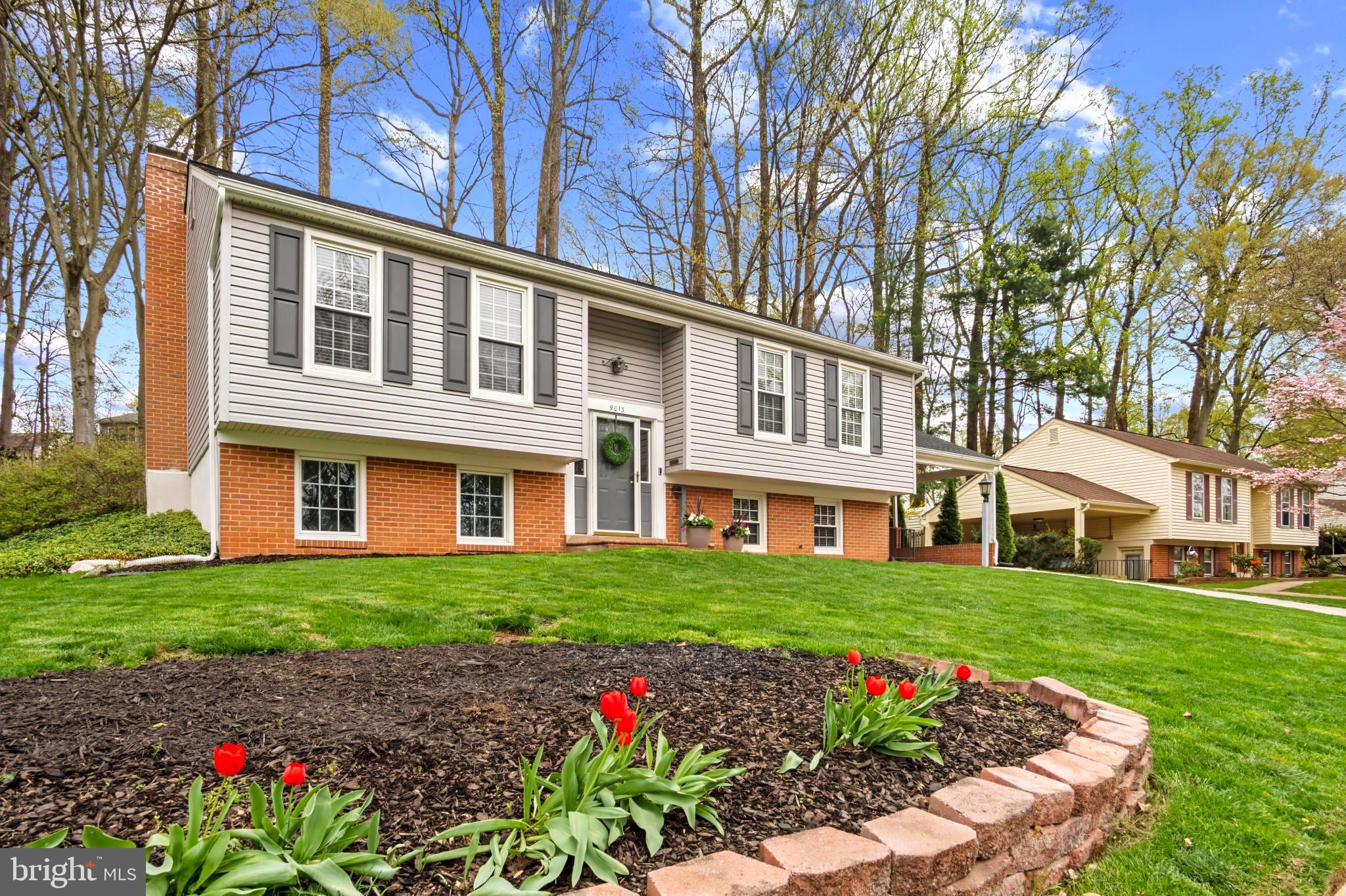 9013 Brook Ford Road Burke, VA 22015 - Photo 3 of 28 a front view of a house with a garden and trees