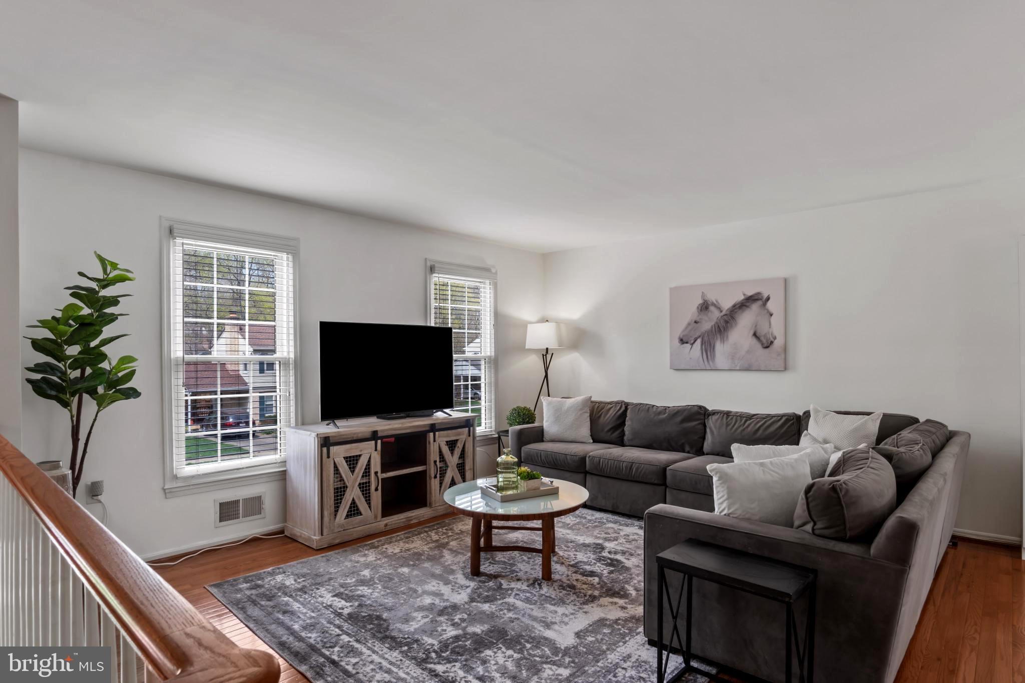 9013 Brook Ford Road Burke, VA 22015 - Photo 5 of 28 a living room with furniture and a flat screen tv