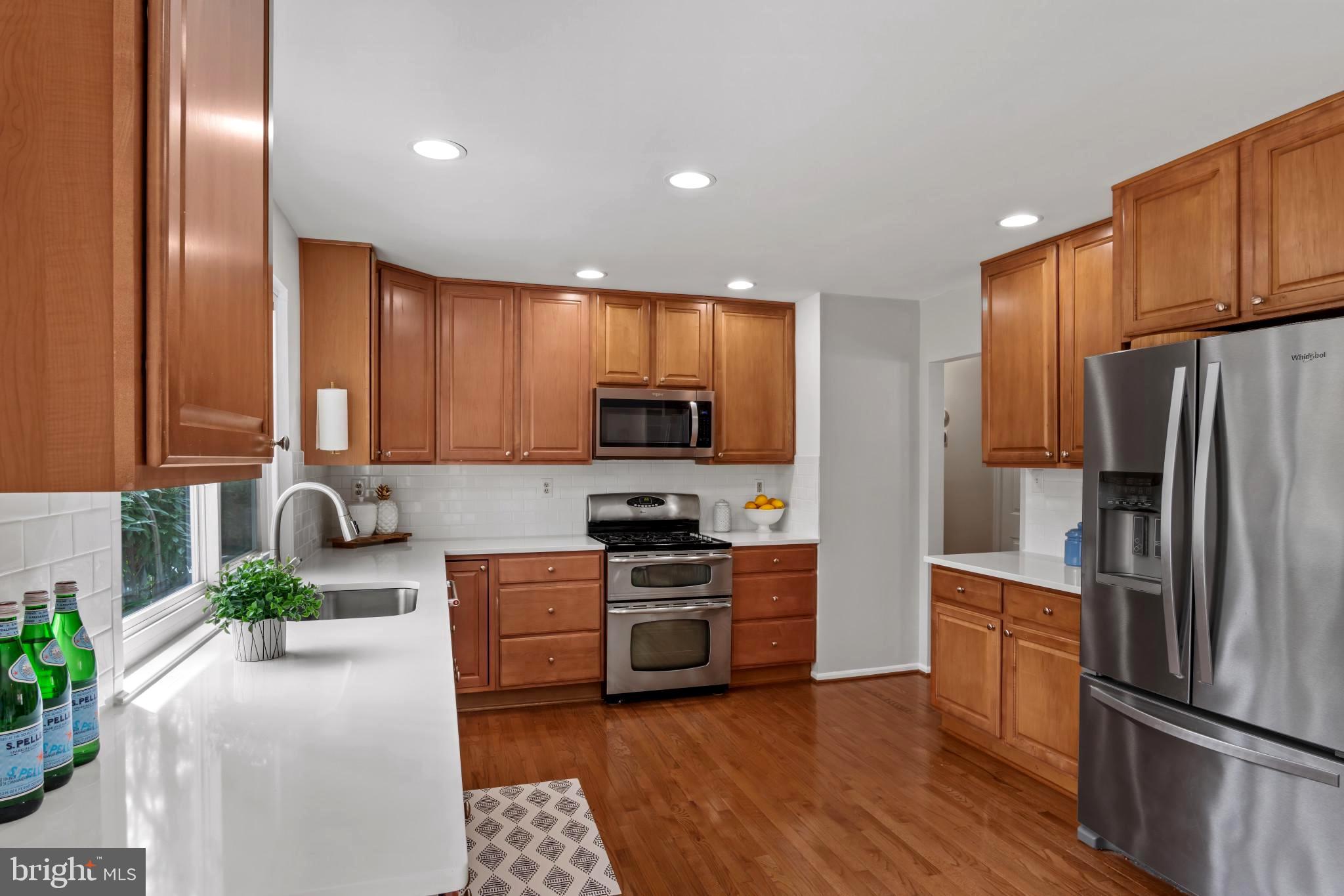 9013 Brook Ford Road Burke, VA 22015 - Photo 9 of 28 a kitchen with stainless steel appliances granite countertop a refrigerator a stove top oven a sink and dishwasher