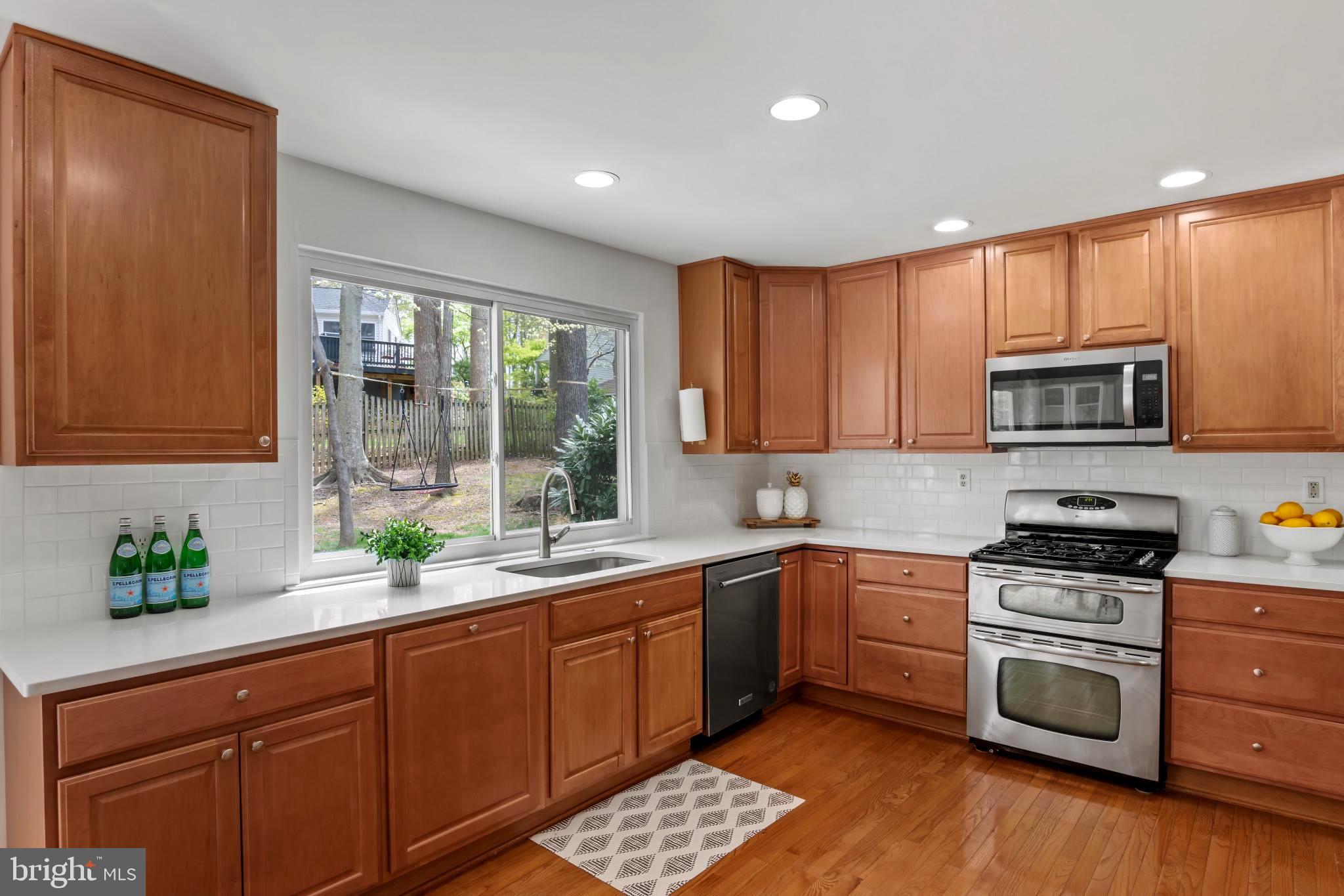 9013 Brook Ford Road Burke, VA 22015 - Photo 10 of 28 a kitchen with stainless steel appliances a sink stove and cabinets