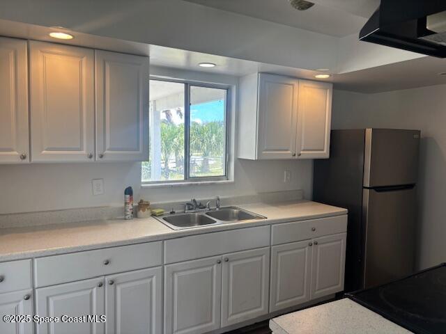 919 Darwin Lane Northeast Palm Bay, FL 32905 - Photo 2 of 14 a kitchen with a sink cabinets and a refrigerator