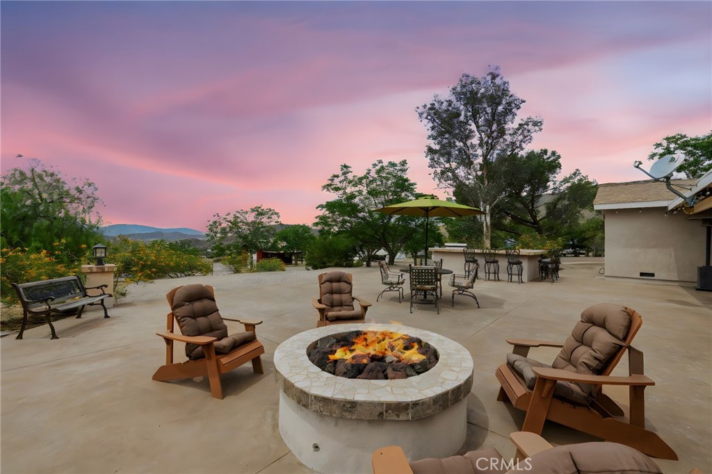 a view of a backyard with sitting area and swimming pool