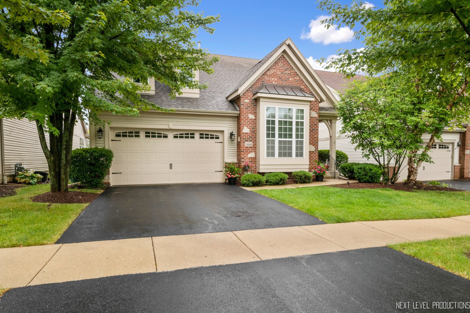 a front view of a house with a yard and a garage