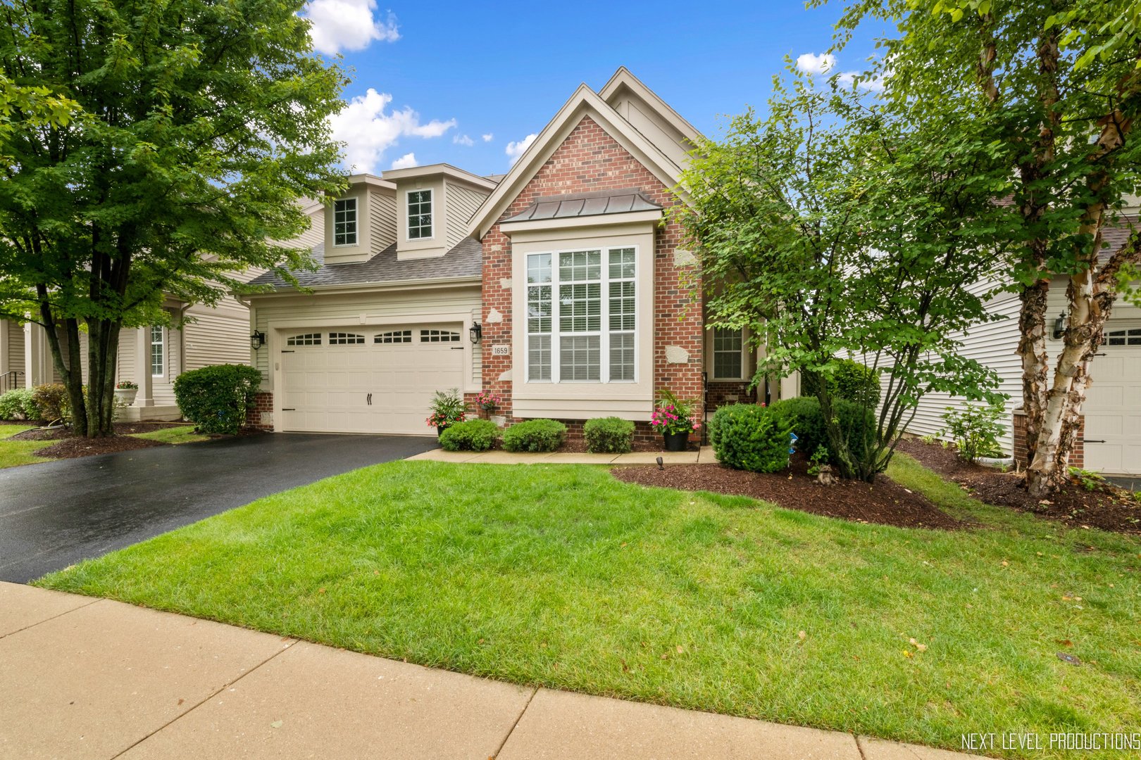 1659 Briarheath Drive Aurora, IL 60505 - Photo 2 of 29 a front view of a house with a garden and plants