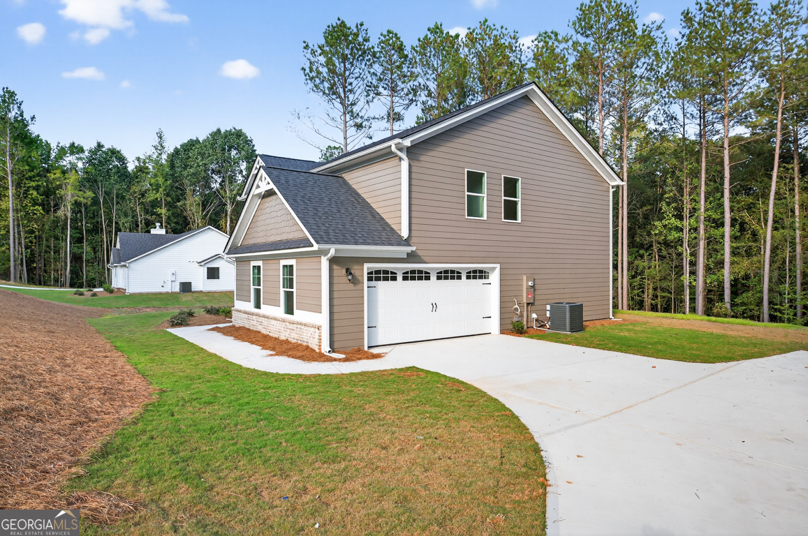 77 Sugar Maple Way, Unit 44 Colbert, GA 30628 - Photo 2 of 30 a front view of a house with a yard and garage