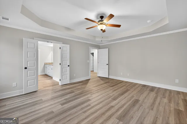 a view of an empty room and wooden floor