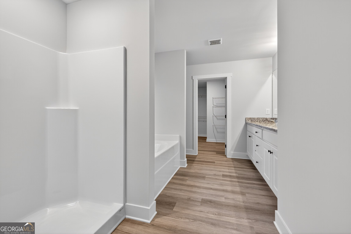 77 Sugar Maple Way, Unit 44 Colbert, GA 30628 - Photo 24 of 30 a view of a hallway with wooden floor and staircase