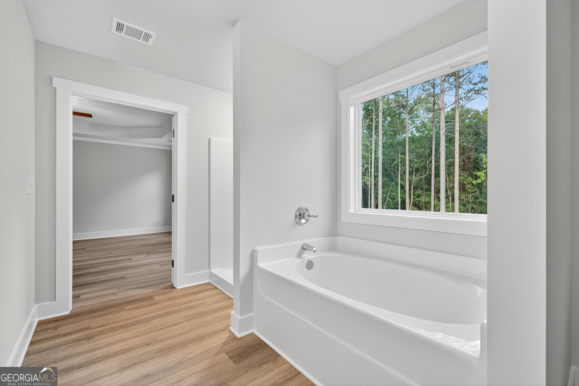 77 Sugar Maple Way, Unit 44 Colbert, GA 30628 - Photo 28 of 30 a bathroom with a bathtub and shower