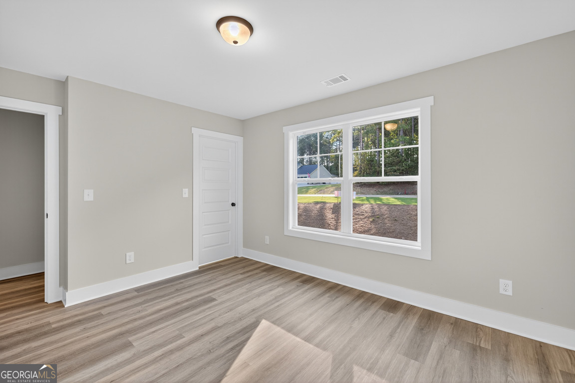77 Sugar Maple Way, Unit 44 Colbert, GA 30628 - Photo 30 of 30 an empty room with wooden floor and windows