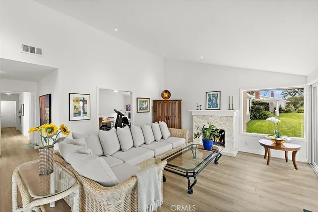 a living room with furniture and a floor to ceiling window