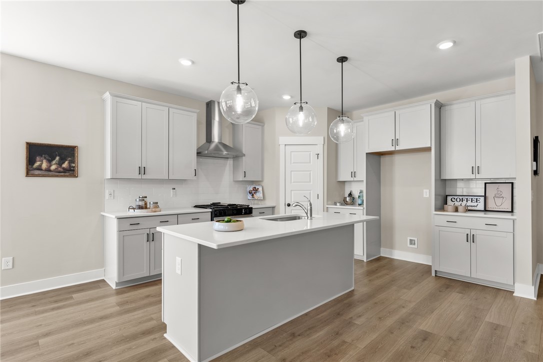 334 Summerall Drive Anderson, SC 29621 - Photo 5 of 28 This bright kitchen features an island, ample cabinetry, and modern lighting.