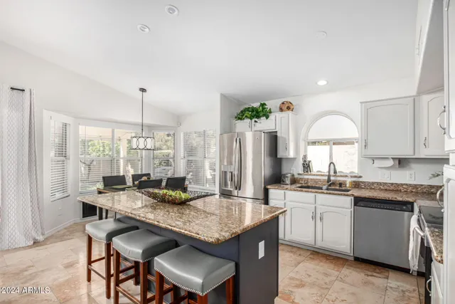 a kitchen with granite countertop lots of counter top space and stainless steel appliances