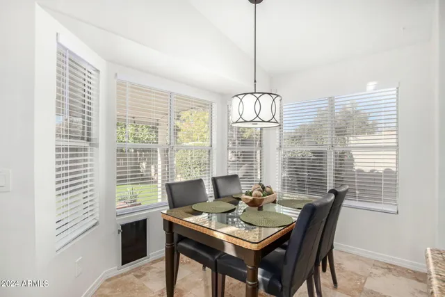 a view of a dining room with furniture window and outside view