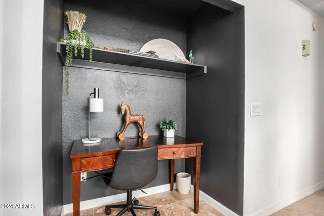 a view of a dining room with a table and chairs