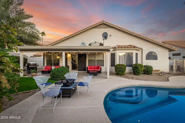 a front view of a house with sitting area