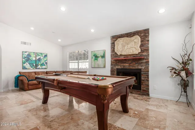 a room with furniture a large window and a fireplace