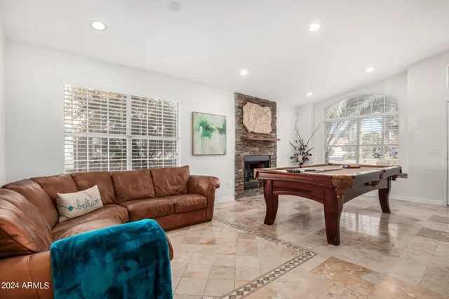 a living room with furniture a table and a large window