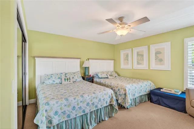 a bedroom with two beds and a chandelier