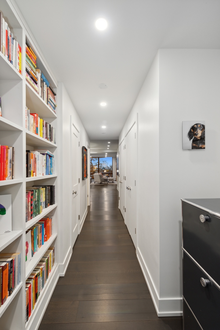 1040 North Lake Shore Drive, Unit 4A Chicago, IL 60611 - Photo 24 of 43 a hallway with wooden floor and book shelf