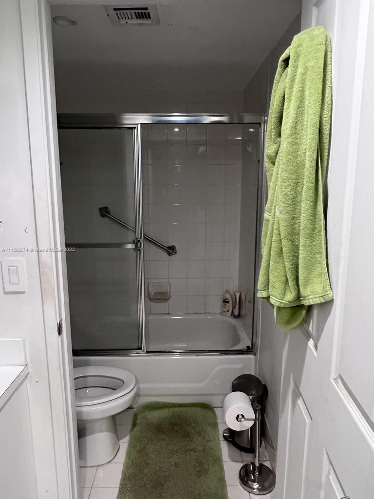 2351 Douglas Road, Unit 908 Miami, FL 33145 - Photo 12 of 17 a bathroom with a toilet and shower