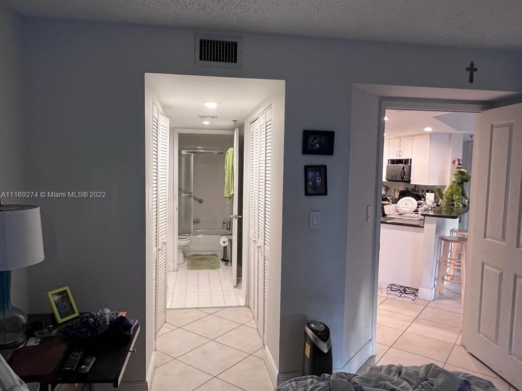 2351 Douglas Road, Unit 908 Miami, FL 33145 - Photo 14 of 17 a view of a hallway to a livingroom with furniture