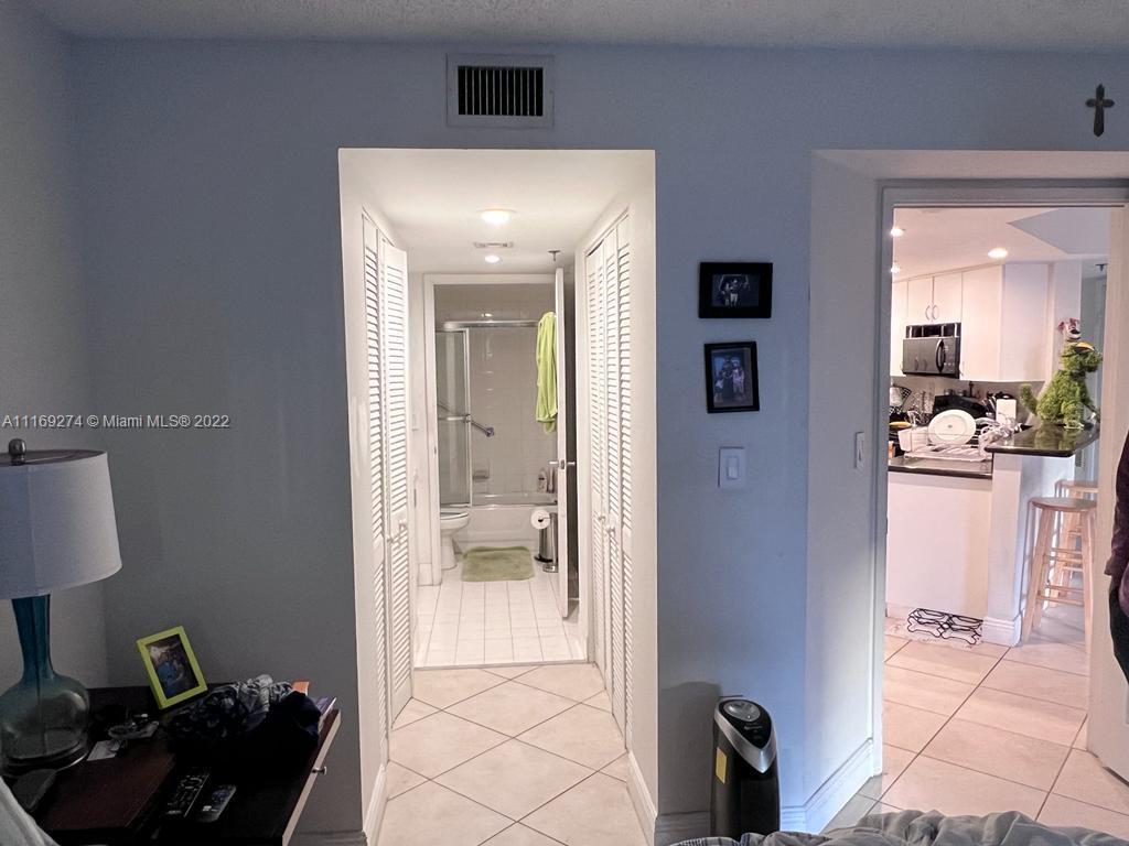 2351 Douglas Road, Unit 908 Miami, FL 33145 - Photo 15 of 17 a en suite bathroom with a toilet sink and mirror