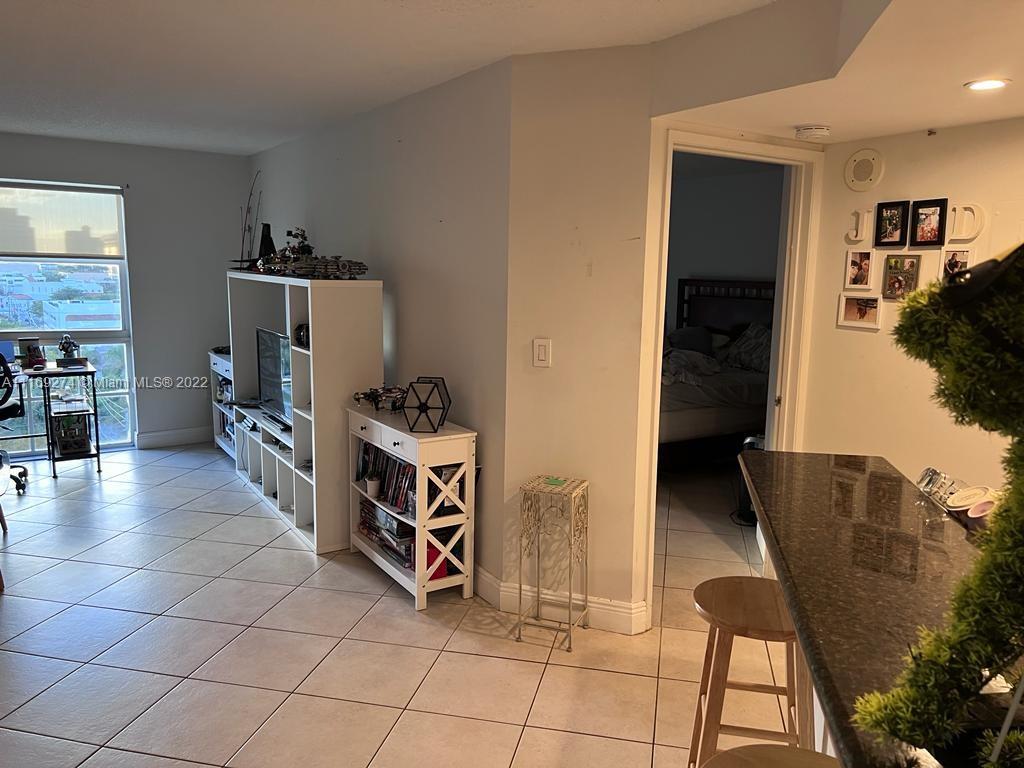 2351 Douglas Road, Unit 908 Miami, FL 33145 - Photo 3 of 17 a view of walk in closet with clothes and shoes