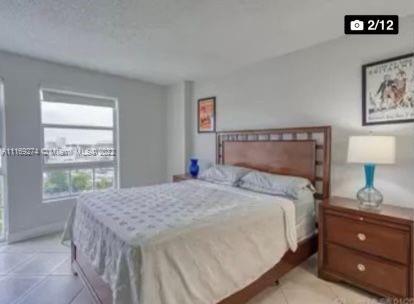 2351 Douglas Road, Unit 908 Miami, FL 33145 - Photo 9 of 17 a bedroom with a bed and a window