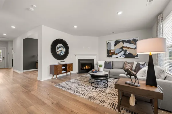 a living room with furniture a clock and a fireplace