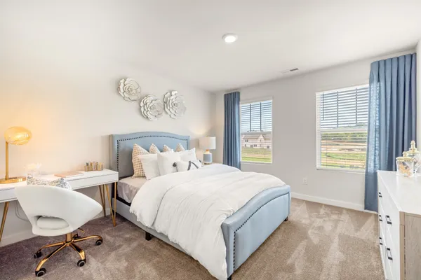 a bedroom with a bed and a lamp
